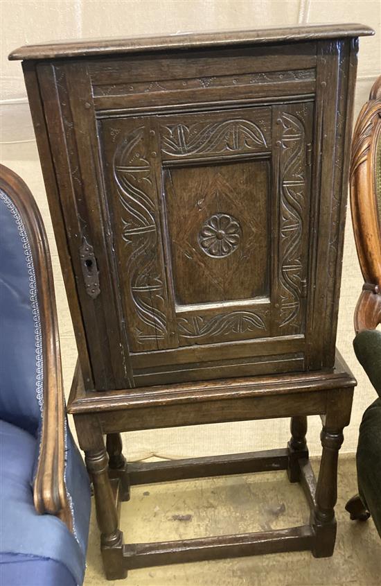 An 18th century design carved oak spice cabinet on associated stand (incorporates old timber), width 50cm, depth 26cm, height 99cm